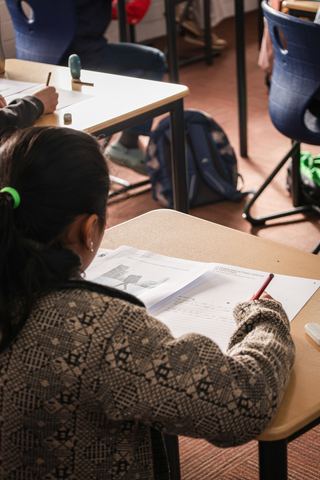A student writing her answers